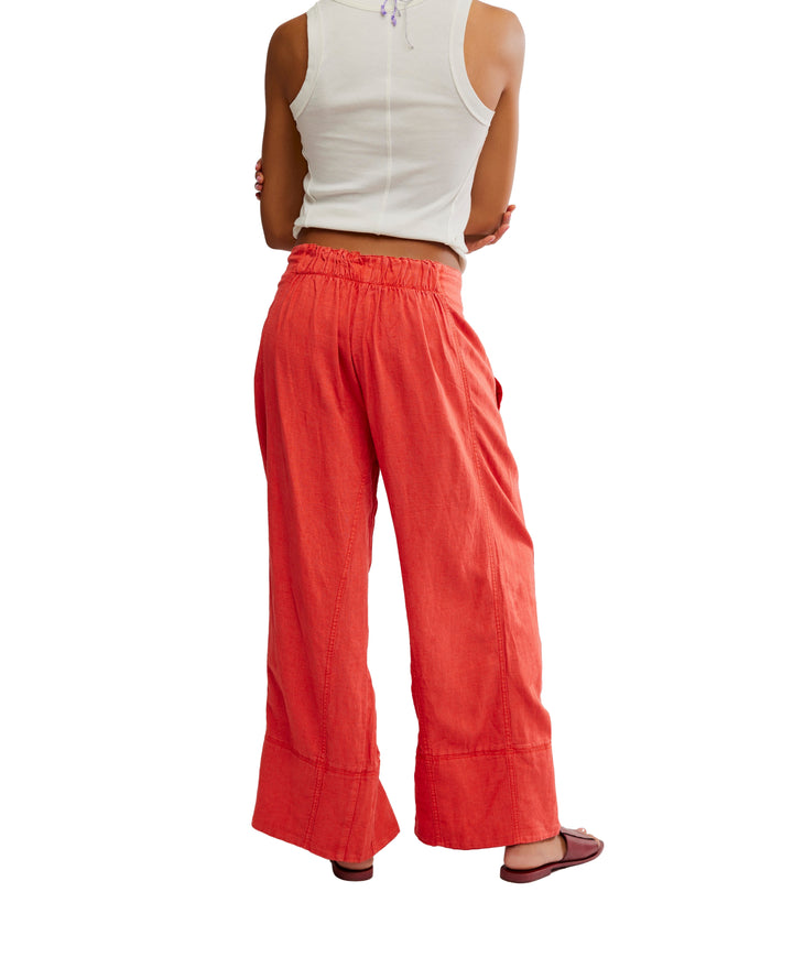 Day's End Linen Pull-On Pants in Poppy Red by Free People, featuring a mid-rise, wide-leg fit, pull-on design, and side pockets.