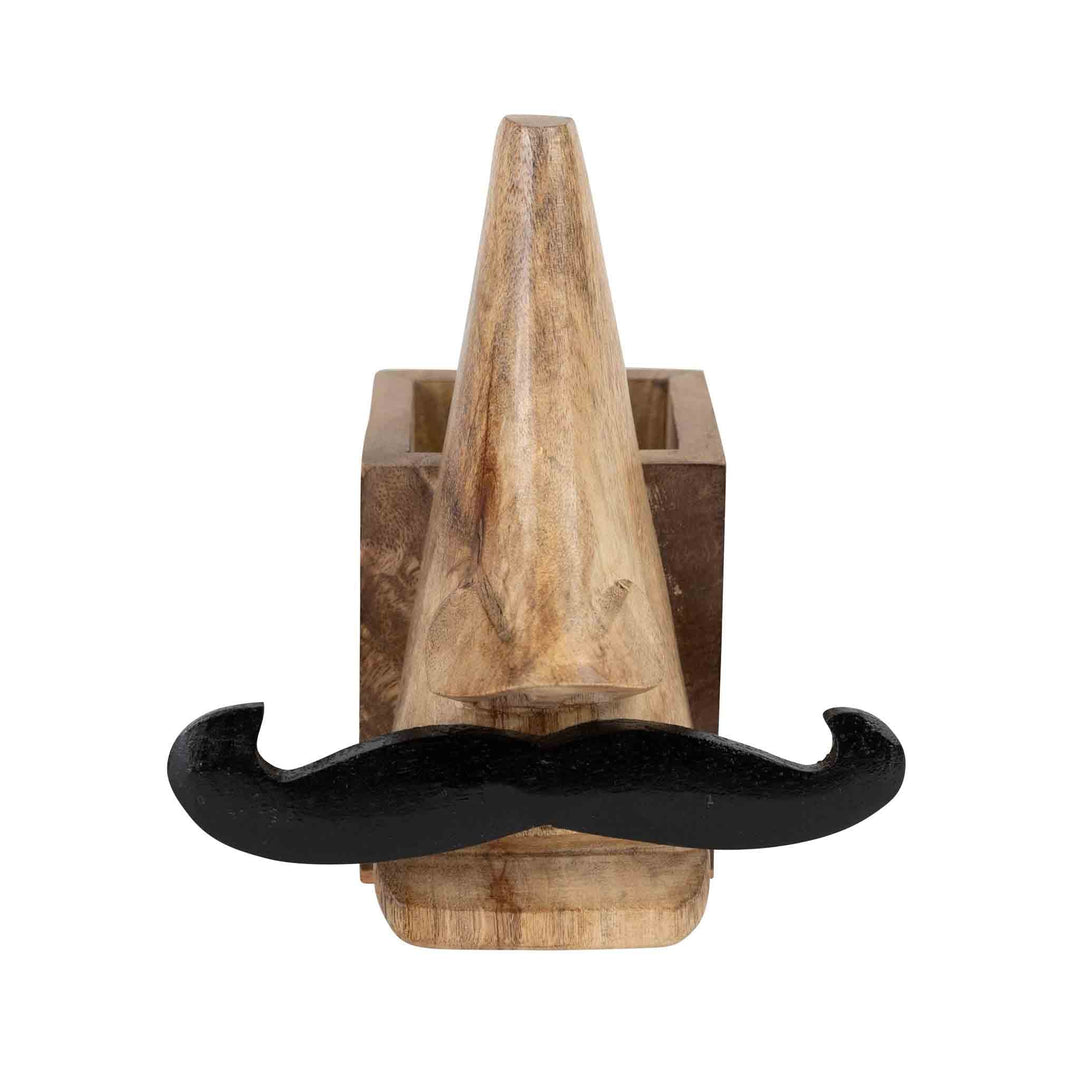 Handcrafted eyeglass and pencil holder made from sustainably sourced mango wood. Features a playful mustache face design in natural and black finishes. Measures 5.5" high with a 2.5" square base. Eco-friendly and easy to clean.